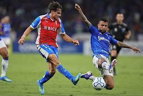 Clemente Montes of Chile's Universidad Catolica, left, and Matheus Henrique of Brazil's Cruzeiro battle for the ball during a Copa Libertadores Group D soccer match in Belo Horizonte, Brazil.
