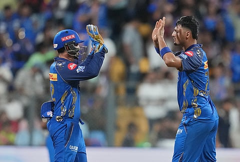Mumbai Indians' Allah Gazanfar , right, celebrates the wicket of Punjab Kings' Cooper Connolly with teammate during the Indian Premier League cricket match between Mumbai Indians and Punjab Kings in Mumbai.