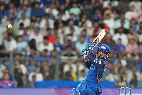 Mumbai Indians' wicketkeeper Quinton de Kock hits a boundary during the Indian Premier League cricket match between Mumbai Indians and Punjab Kings in Mumbai.