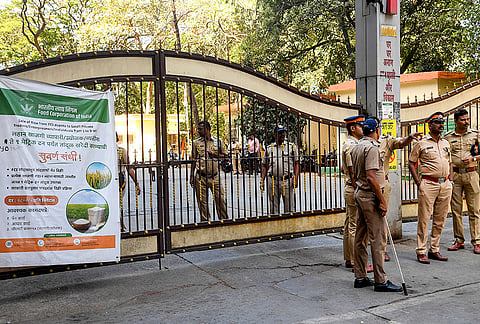 Police personnel stand guard during the inspection of a set of Electronic Voting Machines (EVMs) and Voter verifiable paper audit trail (VVPAT) used in the Chandivali seat during the 2024 state Assembly elections, in Mumbai, Maharashtra.