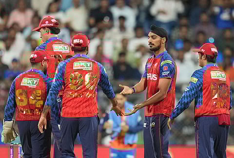 Punjab Kings' Arshdeep Singh, second right, celebrates the wicket of Mumbai Indians' Ryan Rickelton with teammates during the Indian Premier League cricket match between Mumbai Indians and Punjab Kings in Mumbai.
