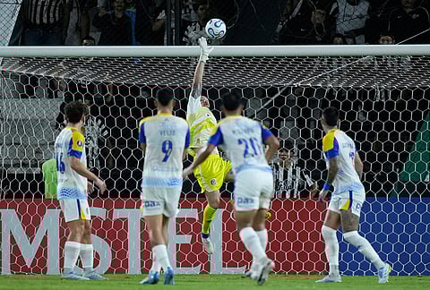 Goalkeeper Jeremias Ledesma of Argentina's Rosario Central, center, makes a save during a Copa Libertadores Group H soccer match against Paraguay's Libertad in Asuncion, Paraguay.
