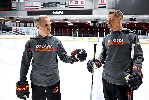 Canada Prime Minister Mark Carney, left, and President of Finland Alexander Stubb speak to reporters as they participate in an Ottawa Charge hockey practice session at TD Place in Ottawa.