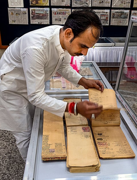 Kishan Kumar Soni, displays his collection of traditional account books, once used for maintaining records, ahead of Bikaner's 539th Foundation Day, in Bikaner, Rajasthan.