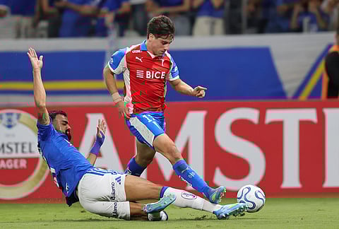 Fabricio Bruno of Brazil's Cruzeiro, left, tries to stop Clemente Montes of Chile's Universidad Catolica during a Copa Libertadores Group D soccer match in Belo Horizonte, Brazil.