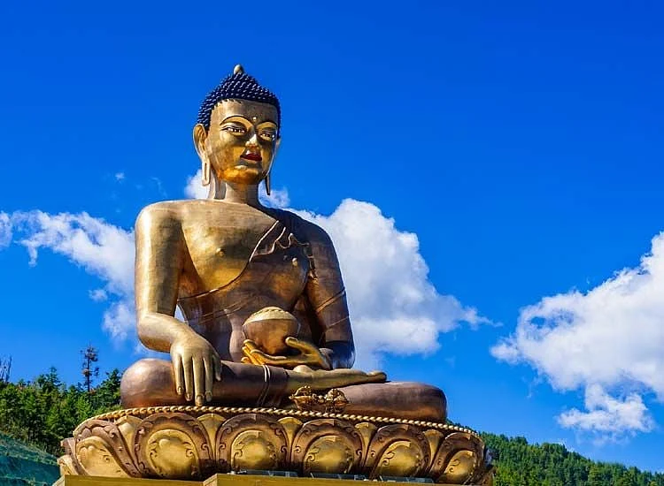 Large golden Buddha Dordenma statue against a blue sky