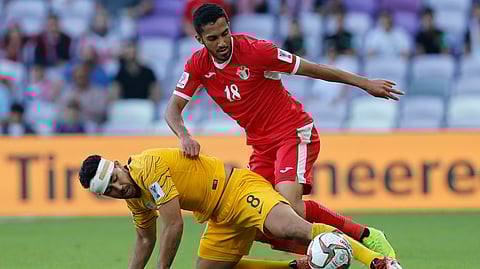 Jordan's midfielder Musa Al-Taamari, top, battles for a ball with Australia's midfielder Massimo Luongo during the AFC Asian Cup group B soccer match between Australia and Jordan at Hazza bin Zayed stadium in Al Ain, United Arab Emirates, Sunday, Jan. 6, 2019.