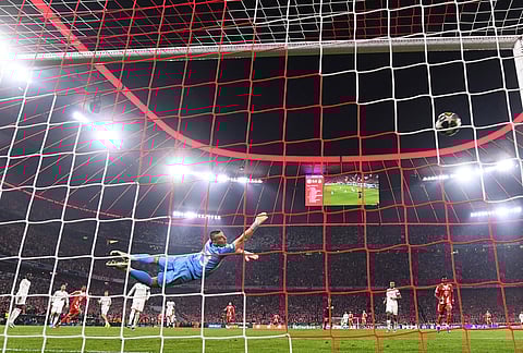 Bayern's Michael Olise scores the goal past Madrid's goalkeeper Andriy Lunin during the Champions League quarterfinal second leg soccer match between Bayern Munich and Real Madrid in Munich, Germany.