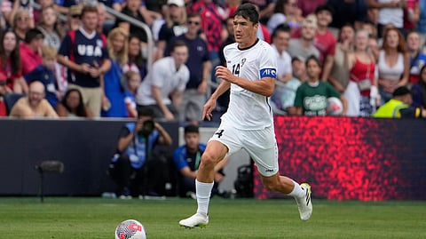 Uzbekistan's Eldor Shomurodov (14) brings the ball down the pitch during the first half of an international friendly soccer match against the United States Saturday, Sept. 9, 2023, in St. Louis. 