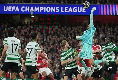 Sporting's goalkeeper Rui Silva punches the ball during the UEFA Champions League second leg quarterfinal soccer match between Arsenal and Sporting in London, England.