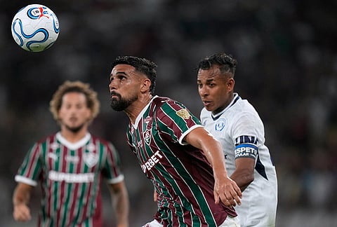 Ignacio of Brazil's Fluminense eyes the ball challenged by Sebastian Villa of Argentina's Independiente Rivadavia, right, during a Copa Libertadores Group C soccer match in Rio de Janeiro.
