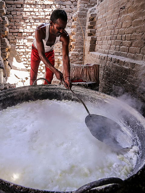 A worker prepares ‘Petha’ a traditional Indian sweet made from ash gourd, in Prayagraj, Uttar Pradesh.