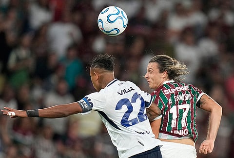 Agustin Canobbio of Brazil's Fluminense, right, and Sebastian Villa of Argentina's Independiente Rivadavia jump for a header during a Copa Libertadores Group C soccer match in Rio de Janeiro.