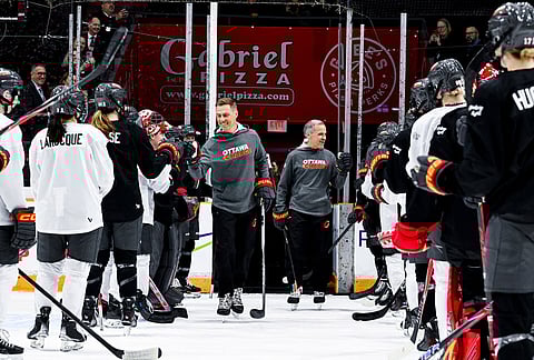 President of Finland Alexander Stubb, left, and Canada Prime Minister Mark Carney fist bump with Ottawa Charge players as they participate in an Ottawa Charge practice session at TD Place in Ottawa.