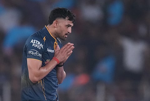 Gujarat Titans' Ashok Sharma celebrates the wicket of Kolkata Knight Riders' Rovman Powell during the Indian Premier League cricket match between Gujarat Titans and Kolkata Knight Riders in Ahmedabad.
