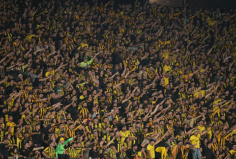 Supporters of Uruguay's Peñarol cheer their team on during a Copa Libertadores Group E soccer match against Argentina's Platense in Montevideo, Uruguay.