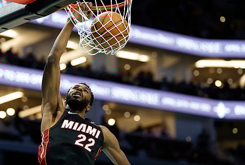 Miami Heat forward Andrew Wiggins dunks against the Charlotte Hornets during the second half of an NBA play-in tournament basketball game in Charlotte, 
North Carolina.