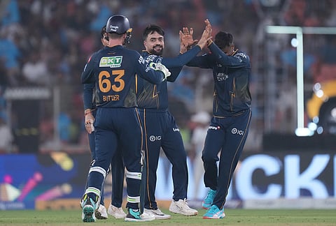 Gujarat Titans' Rashid Khan, centre, celebrates with teammates the wicket of Kolkata Knight Riders' Cameron Green during the Indian Premier League cricket match between Gujarat Titans and Kolkata Knight Riders in Ahmedabad.