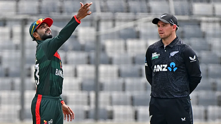 Bangladesh's captain Mehidy Hasan Miraz, left, tosses the coin as New Zealand's captain Tom Latham looks on before the start of the first one day international cricket match between Bangladesh and New Zealand in Mirpur, Bangladesh, Friday, April 17, 2026. - AP Photo