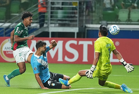 Luighi of Brazil's Palmeiras, left, makes an attempt to score against Peru's Sporting Cristal during a Copa Libertadores Group F soccer match in Sao Paulo.