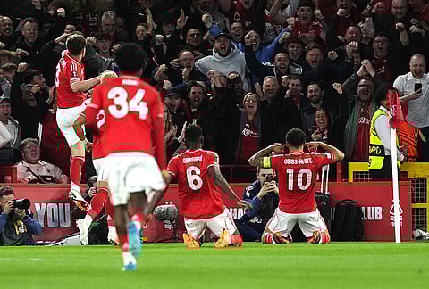 Nottingham Forest's Morgan Gibbs-White, right, celebrates scoring during the Europa League quarterfinal second leg soccer match between Nottingham Forest and Porto in Nottingham, England.