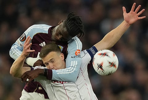 Aston Villa's Amadou Onana, left, Bologna's Lewis Ferguson battle for the ball during the Europa League quarterfinal second leg soccer match between Aston Villa and Bologna, in Birmingham, England.