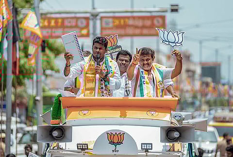 BJP leader K Annamalai, left, during a roadshow in support of NDA candidate Vidiyal S Sekar ahead of the Assembly elections, in Ottanatham, Thoothukkudi district of Tamil Nadu. 