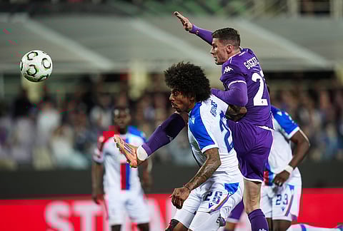 Fiorentina's Robin Gosens, right, fights for the ball with Crystal Palace's Chris Richards during the Conference League quarterfinal second leg soccer match between Fiorentina and Crystal Palace in Florence, Italy.