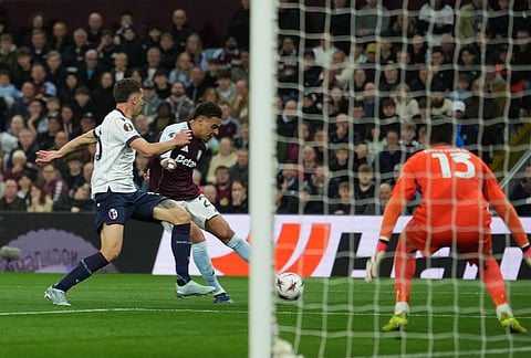 Aston Villa's Morgan Rogers scores his side's third goal during the Europa League quarterfinal second leg soccer match between Aston Villa and Bologna, in Birmingham, England.