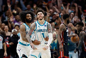 | Photo: AP/Nell Redmond : Charlotte Hornets guard LaMelo Ball (1) celebrates with guard Coby White after scoring against the Miami Heat during the second half of an NBA play-in tournament basketball game in Charlotte, North Carolina.