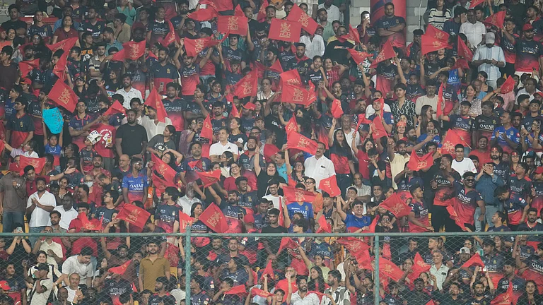 Royal Challengers Bengaluru supporters cheers after Tim David hits a boundary during the Indian Premier League cricket match between Royal Challengers Bengaluru and Lucknow Super Giants in Bengaluru, India, Wednesday, April 15, 2026. - | Photo: AP/Aijaz Rahi