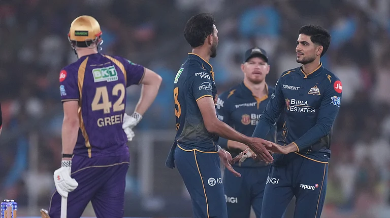 Gujarat Titans' Prasidh Krishna, second left, celebrates with captain Shubman Gill the wicket of Kolkata Knight Riders' Anukul Roy during the Indian Premier League cricket match between Gujarat Titans and Kolkata Knight Riders in Ahmedabad, India, Friday, April 17, 2026. - (AP Photo/Ajit Solanki)