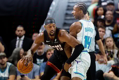 Miami Heat center Bam Adebayo, left, drives against Charlotte Hornets forward Moussa Diabate during the first half of an NBA play-in tournament basketball game in Charlotte, North Carolina.