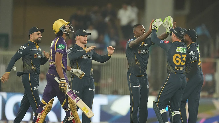 Gujarat Titans' Kagiso Rabada, third from right, celebrates with teammates the wicket of Kolkata Knight Riders' Angkrish Raghuvanshi, left, walks during the Indian Premier League cricket match between Gujarat Titans and Kolkata Knight Riders in Ahmedabad, India, Friday, April 17, 2026. - (AP Photo/Ajit Solanki)