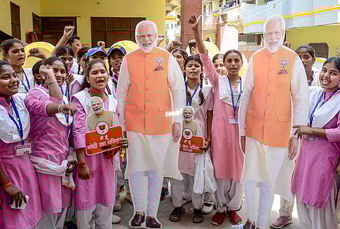 School students hold cutouts of Prime Minister Narendra Modi as they participate in a programme on Nari Shakti Vandan Adhiniyam, also known as the Women's Reservation Act, in Mirzapur, Uttar Pradesh.