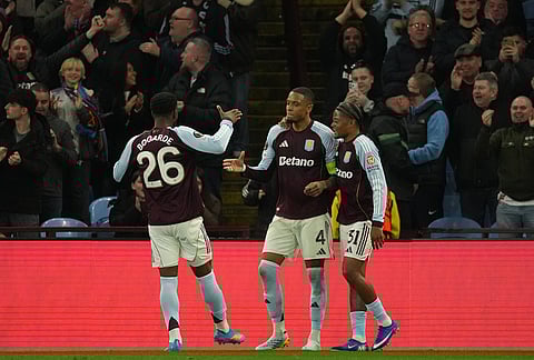 Aston Villa's Ezri Konsa, center, celebrates after scores his side's fourth goal during the Europa League quarterfinal second leg soccer match between Aston Villa and Bologna, in Birmingham, England.