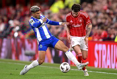 Porto's Carvalho William, left, and Nottingham Forest's Neco Williams battle for the ball during the Europa League quarterfinal second leg soccer match between Nottingham Forest and Porto in Nottingham, England.