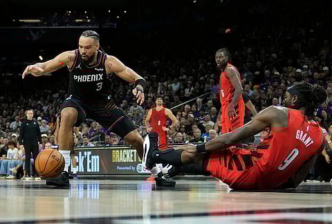 Phoenix Suns forward Dillon Brooks (3) goes after a loose ball as Portland Trail Blazers forward Jerami Grant (9) falls down during the second half of an NBA play-in tournament basketball game, in Phoenix.