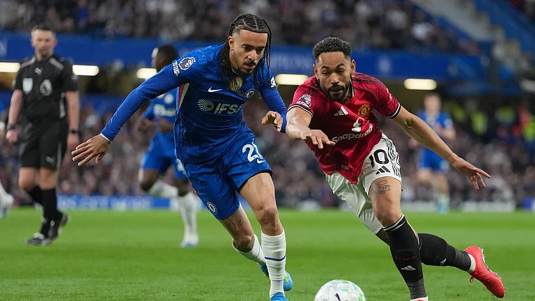Manchester United's Matheus Cunha, right, and Chelsea's Malo Gusto challenge for the ball during the English Premier League soccer match between Chelsea and Manchester United in London, Saturday, April 18, 2026. - (AP Photo/Kirsty Wigglesworth)