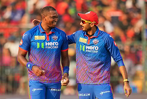 Delhi Capitals' captain Axar Patel congratulates Lungi Ngidi during the Indian Premier League cricket match between Royal Challengers Bengaluru and Delhi Capitals in Bengaluru.