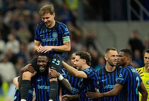 Inter Milan's Nicolo Barella, on Marcus Thuram shoulders, celebrates after scoring his side's 2nd goal during the Serie A soccer match between Inter Milan and Cagliari in Milan, Italy.