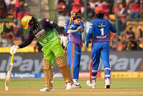 Delhi Capitals' Kuldeep Yadav celebrates the dismissal of Royal Challengers Bengaluru's Phil Salt during the Indian Premier League cricket match between Royal Challengers Bengaluru and Delhi Capitals in Bengaluru.