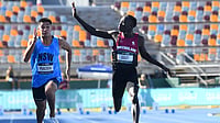 AP Photo : Gout Gout, right, waves while winning the junior 100-meter race at the Australian Athletics Junior Championship in Brisbane. 