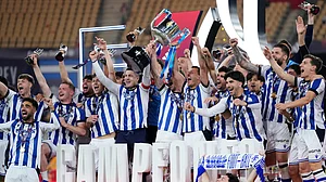 (AP Photo/Jose Breton) : Real Sociedad's team players celebrate with the trophy after the Copa del Rey final soccer match between Atletico Madrid and Real Sociedad in Seville, Spain, early Sunday, April. 19, 2026.