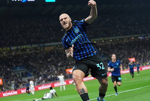 Inter Milan's Federico Dimarco celebrates after his teammate Marcus Thuram scored the opening goal during the Serie A soccer match between Inter Milan and Cagliari in Milan, Italy.