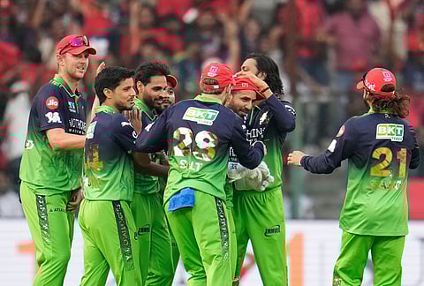 Royal Challengers Bengaluru's Bhuvneshwar Kumar, third left, and wicketkeeper Jitesh Sharma, third right, celebrate with teammates the dismissal of Delhi Capitals' Sameer Rizvi during the Indian Premier League cricket match between Royal Challengers Bengaluru and Delhi Capitals in Bengaluru.
