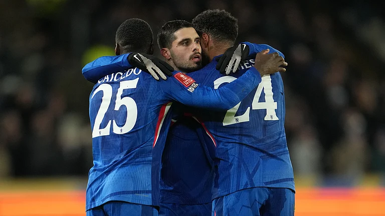 Chelsea's Moises Caicedo, left, and Reece James hug Pedro Neto after he scored during the English FA Cup fourth round soccer match between Hull City and Chelsea in Hull, England, Friday, Feb. 13, 2026. - (AP Photo/Jon Super)