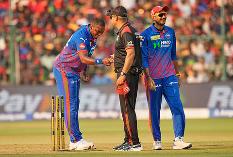 Delhi Capitals' Lungi Ngidi returns the bail to umpire after the dismissal of Royal Challengers Bengaluru's Krunal Pandya during the Indian Premier League cricket match between Royal Challengers Bengaluru and Delhi Capitals in Bengaluru.
