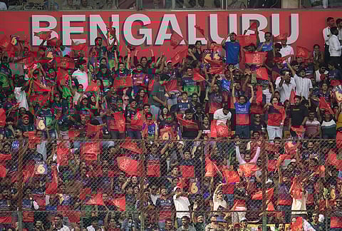 Royal Challengers Bengaluru's fans cheer and watch the play during the Indian Premier League cricket match between Royal Challengers Bengaluru and Delhi Capitals in Bengaluru.