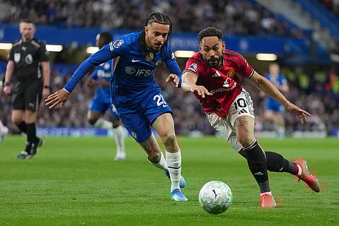 Manchester United's Matheus Cunha, right, and Chelsea's Malo Gusto challenge for the ball during the English Premier League soccer match between Chelsea and Manchester United in London.